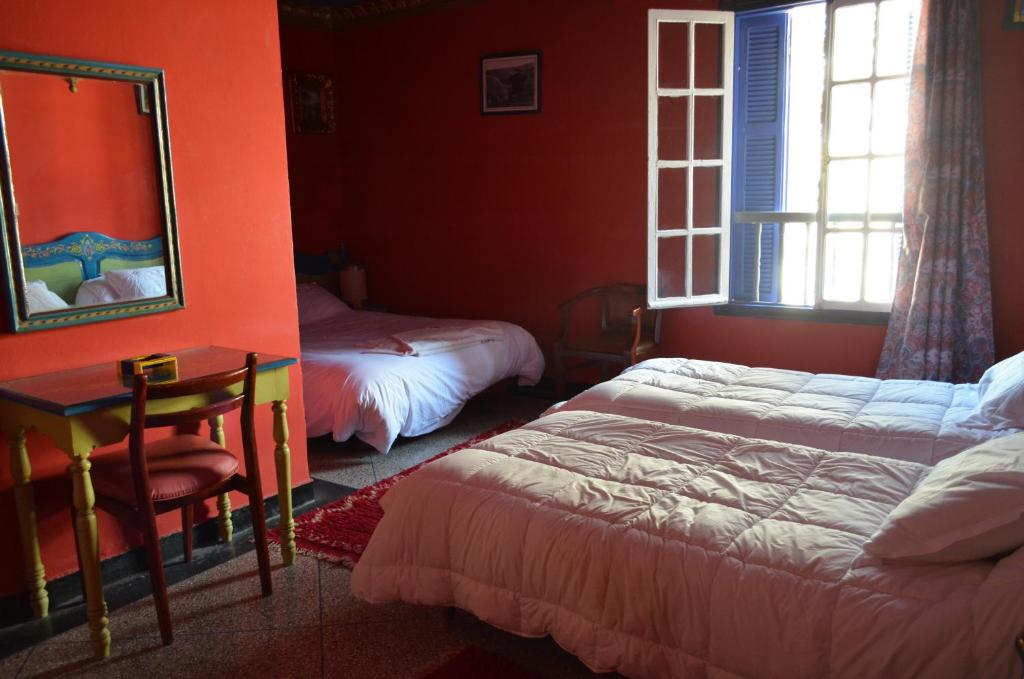 Postel nebo postele na pokoji v ubytování Hotel Sahara