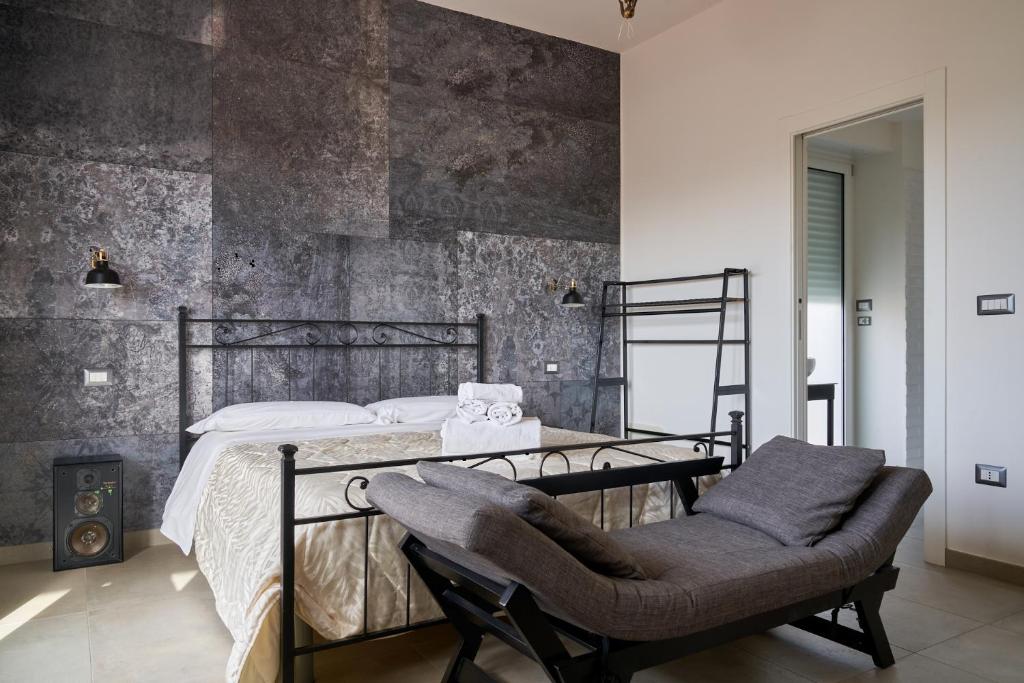 ein Schlafzimmer mit einem Metallbett und einem Stuhl in der Unterkunft Freshwater Pirates in Gaeta