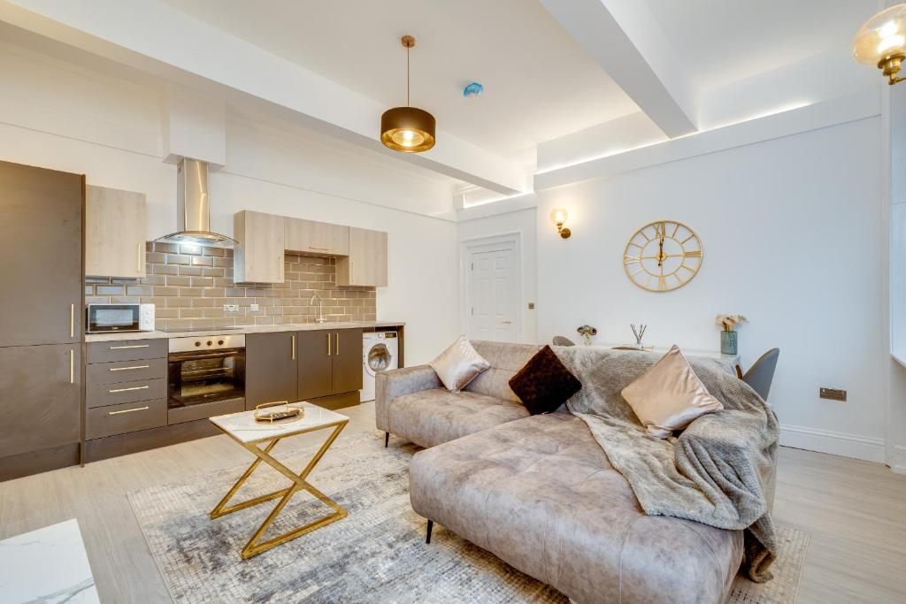 a living room with a couch and a table at Town House Apartments in Wakefield