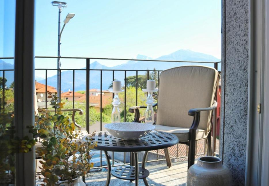 a patio with a table and a chair on a balcony at Civico Sei in Menaggio