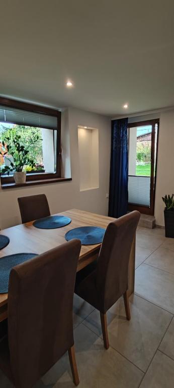 a dining room with a table and chairs at Apartament Kopernik in Bystrzyca Kłodzka