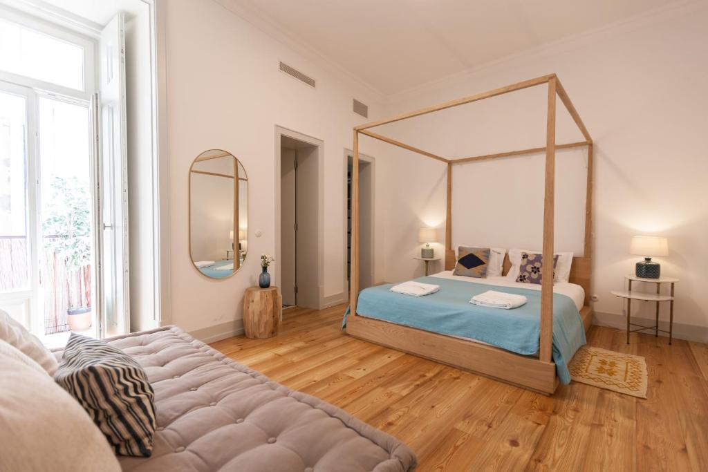 a bedroom with a large bed with a large mirror at FLH Lux Baixa Flat - Historical Center near Tejo River in Lisbon