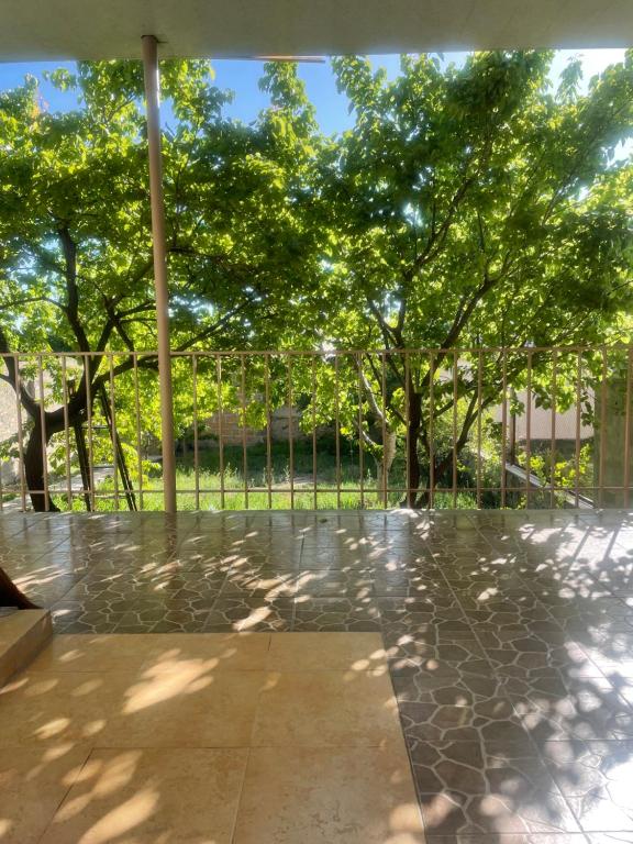 a view of a patio with trees in the background at Nelly's Home in Yerevan