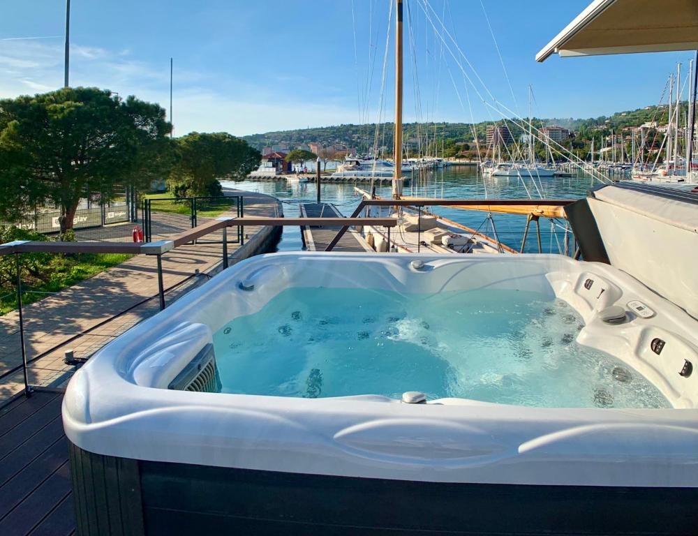 a jacuzzi tub on the deck of a boat at BellaVista HouseBoat Apartment Portorose in Portorož