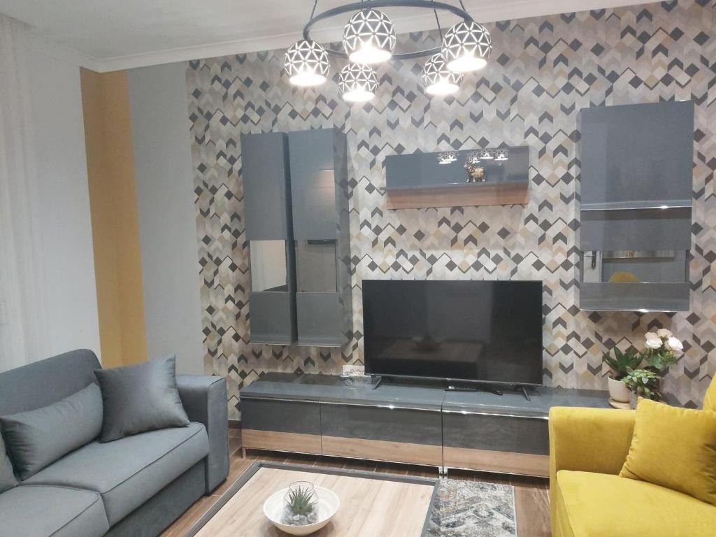 een woonkamer met een grote flatscreen-tv bij Apartman Golden in Senta