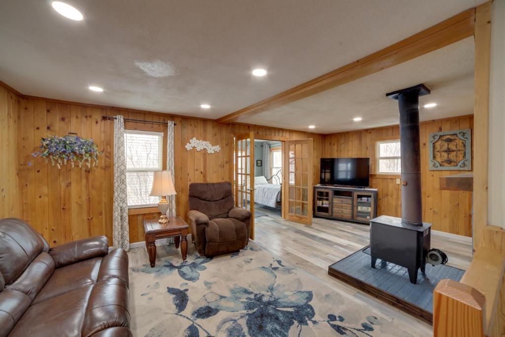 a living room with a leather couch and a fireplace at Inviting Missouri River Vacation Rental 2 Mi Away in Great Falls