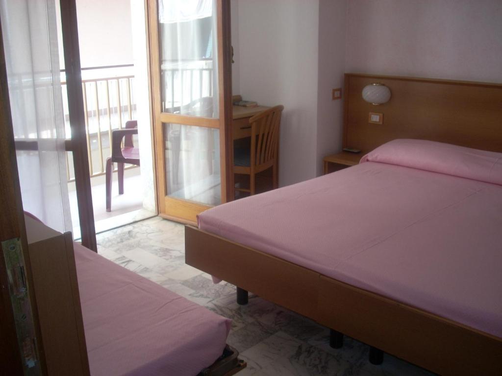 Postel nebo postele na pokoji v ubytování Hotel Corallo