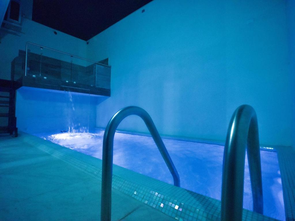 a swimming pool with blue lights in a building at Casa Pardo in Monterrey