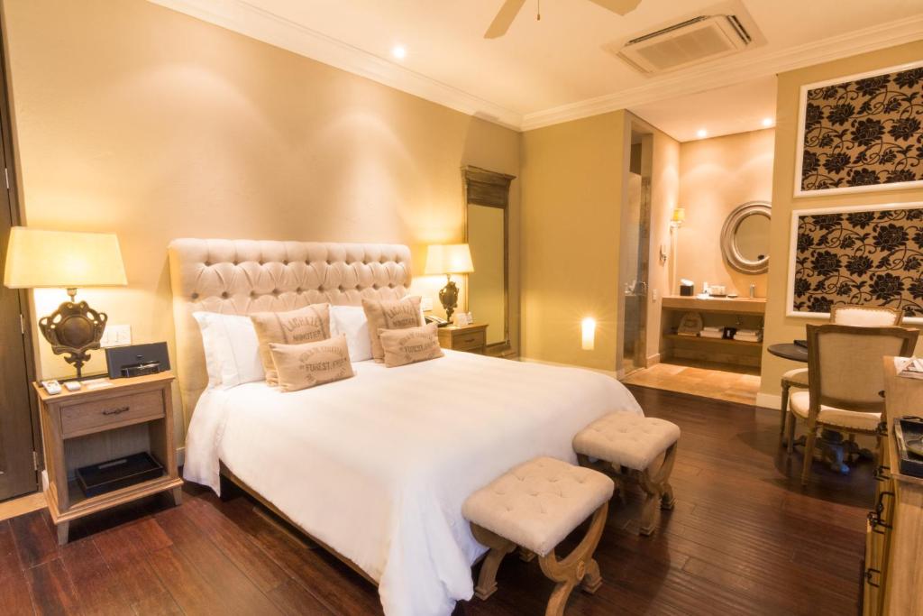 Postel nebo postele na pokoji v ubytování Bastión Luxury Hotel