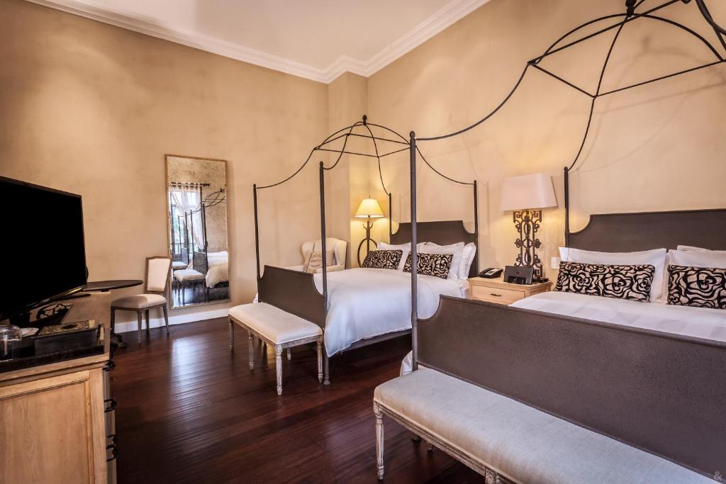 Postel nebo postele na pokoji v ubytování Bastión Luxury Hotel