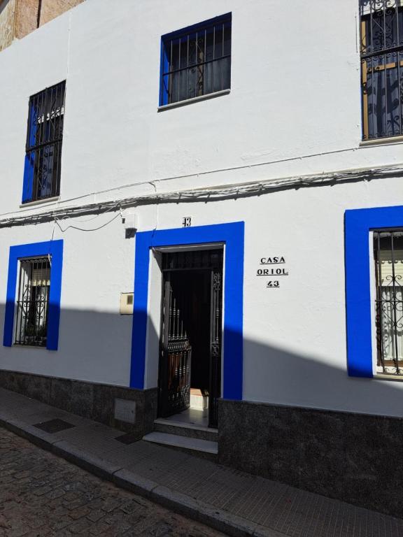 a white and blue building with a door at CASA ORIOL in Ayamonte