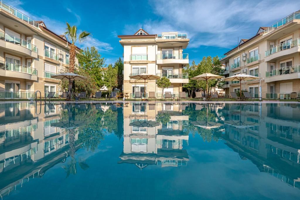 a hotel with a pool in front of a building at Belek Deluxe Suit in Belek