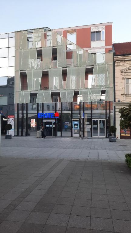 un gran edificio con muchas ventanas de cristal en Apartman Tena en Vukovar