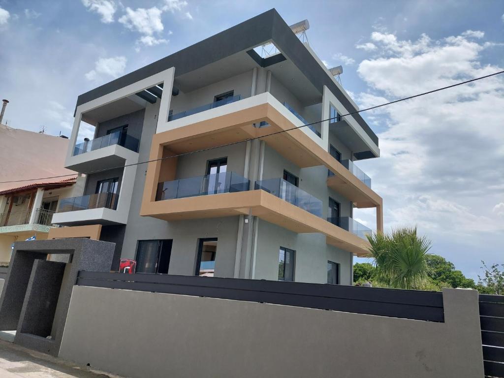 a white building with a fence in front of it at Luana Monte Apartments in Amoudara Herakliou