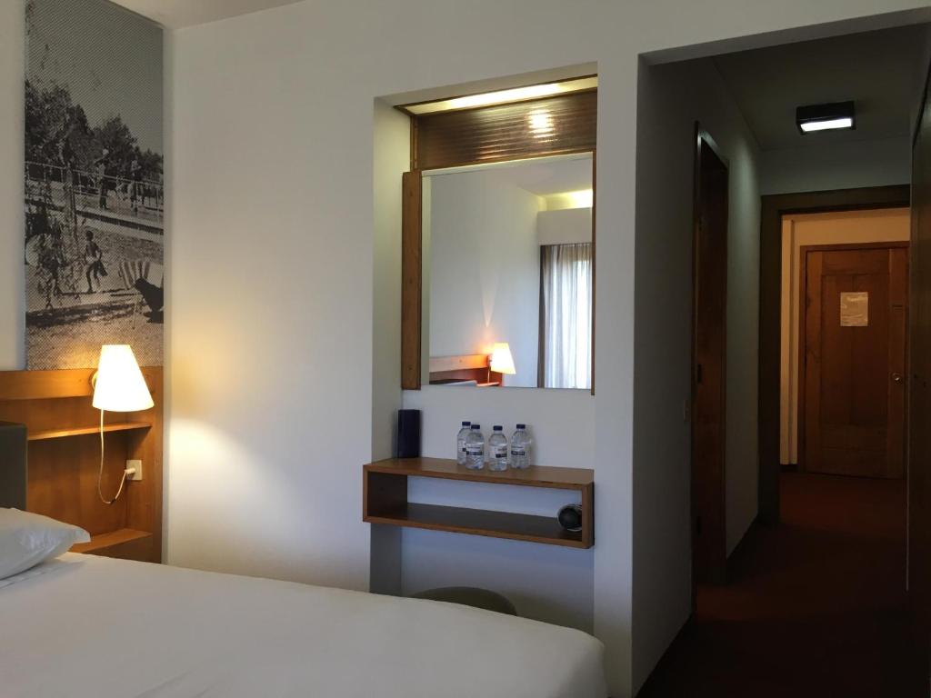 Postel nebo postele na pokoji v ubytování Parque do Rio Ofir Hotel