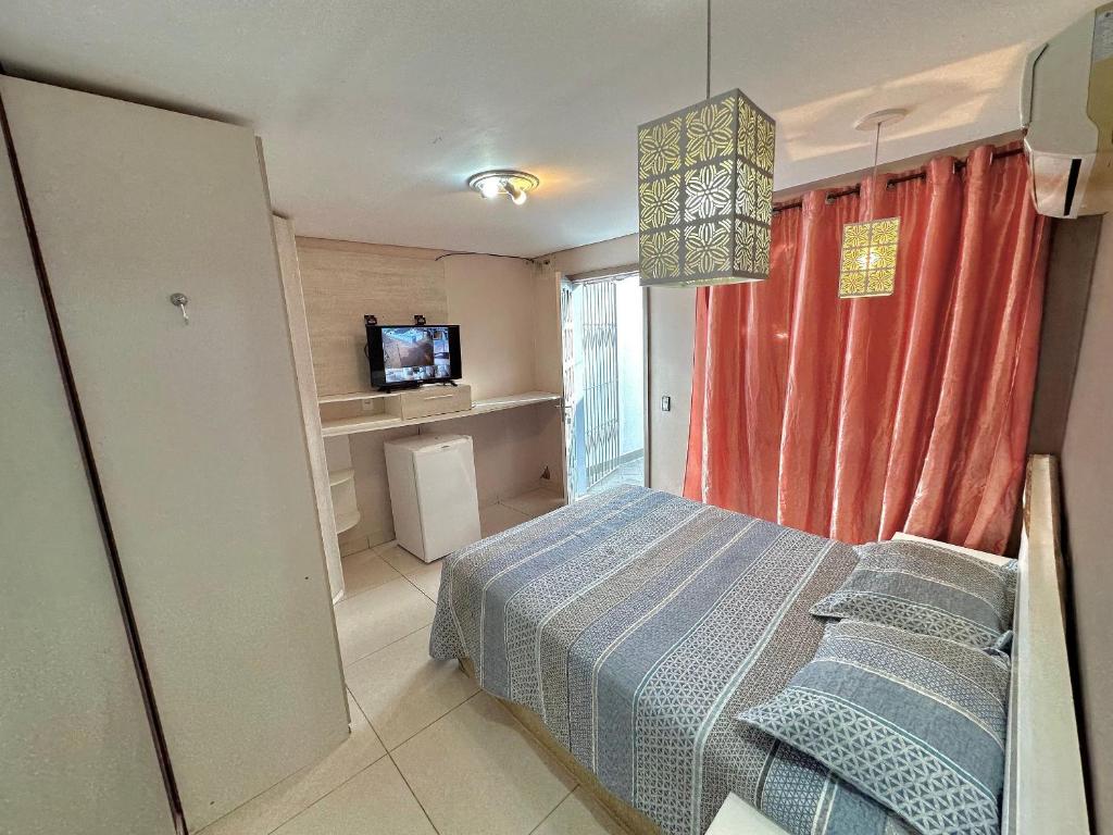 a bedroom with a bed and a television in it at Pousada Residencial - PVH in Porto Velho