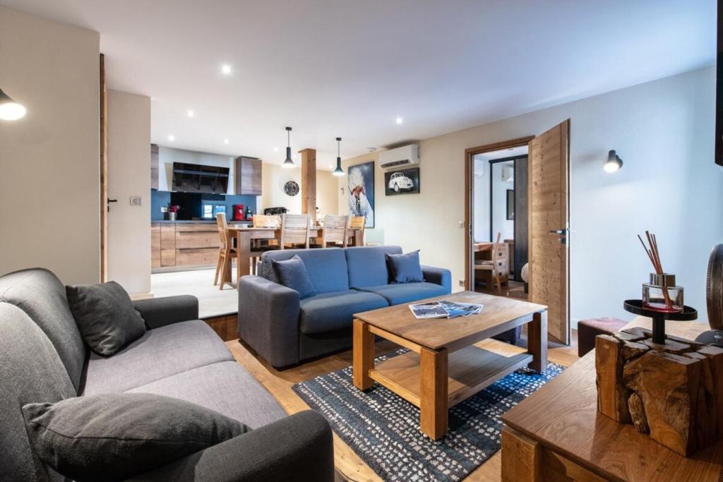 ein Wohnzimmer mit einem Sofa und einem Tisch in der Unterkunft APPALACHES Annecy Rent Lodge in Annecy