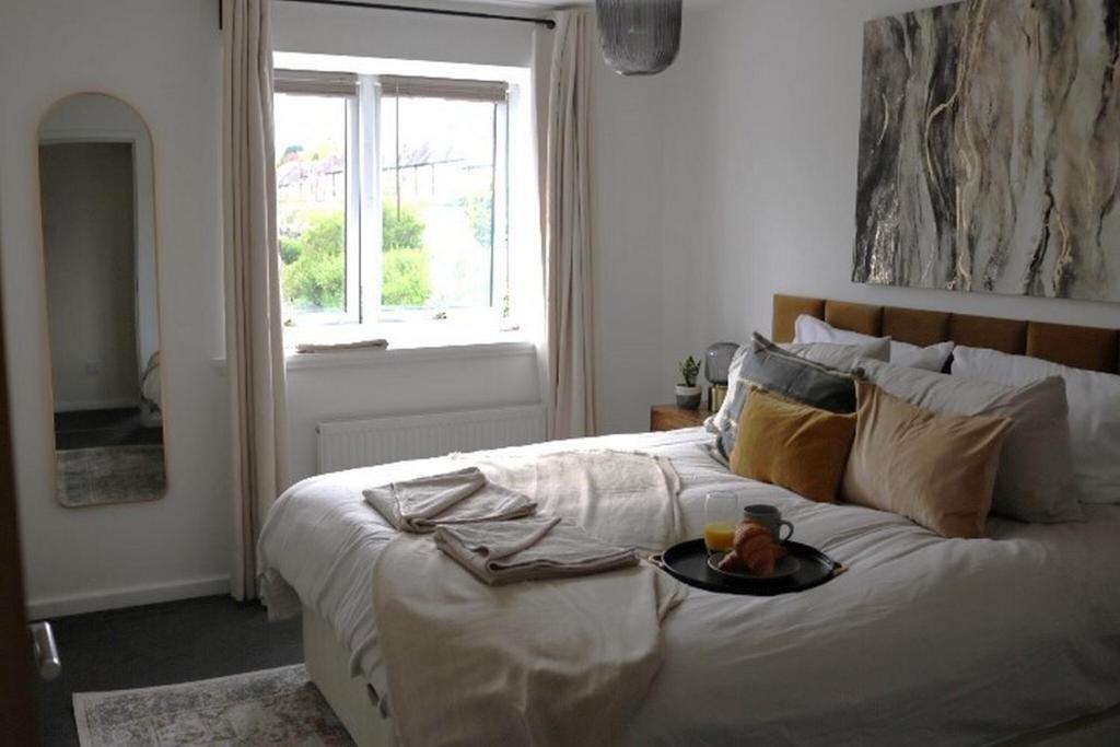 a bedroom with a bed with a tray of food on it at Charming 2 Bed House - Family Friendly in Nottingham