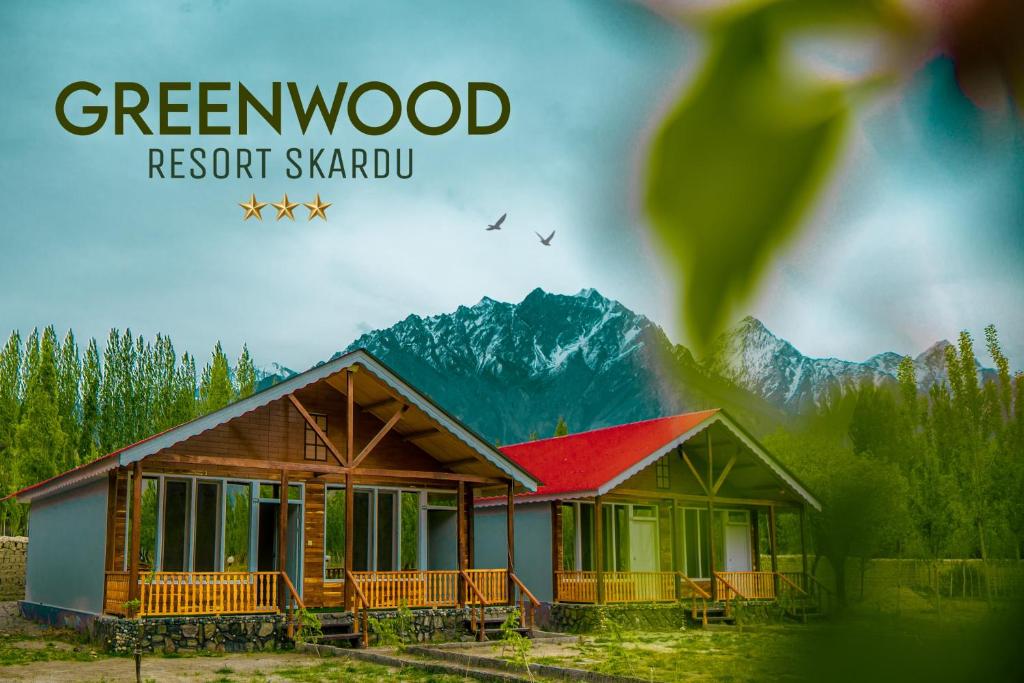 a picture of a house with mountains in the background at Greenwood Resort Skardu in Skardu