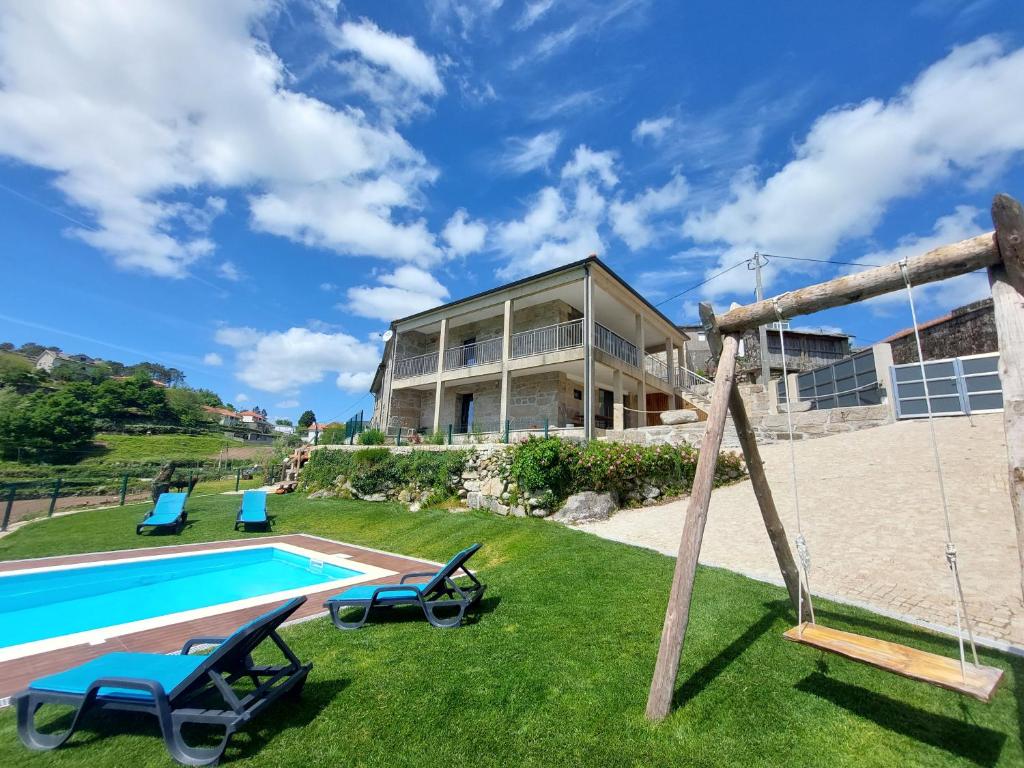 a villa with a swimming pool and a house at Casa da Carreira in Mondim de Basto