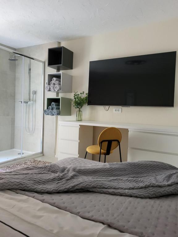 a bedroom with a bed with a flat screen tv at Old Town Sedlar Apartment in Split