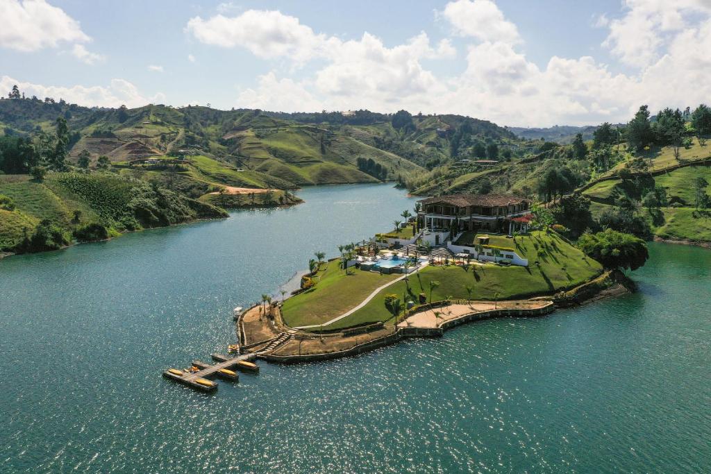 an aerial view of a house on an island in a river at Hotel La Magdalena Adult Only in Guatapé