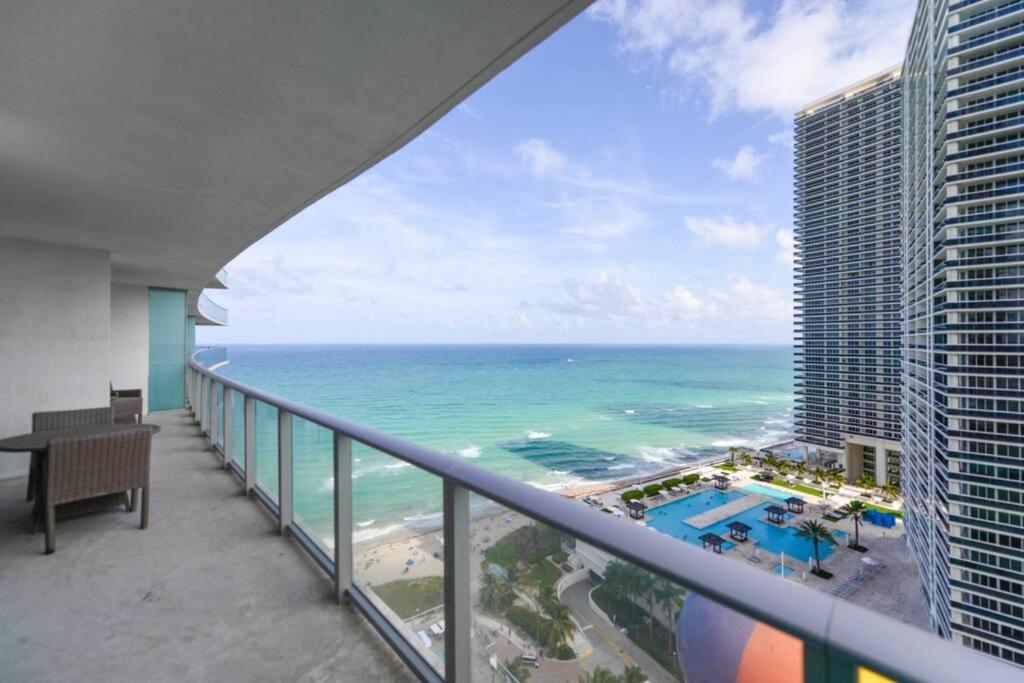 a view of the ocean from the balcony of a building at Gorgeous Views Await in Your Beachfront Condo in Hollywood