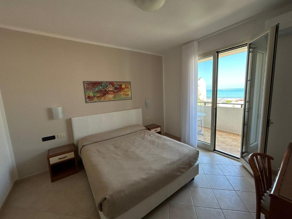 a bedroom with a bed and a view of the ocean at Bikini Hotel in Vieste