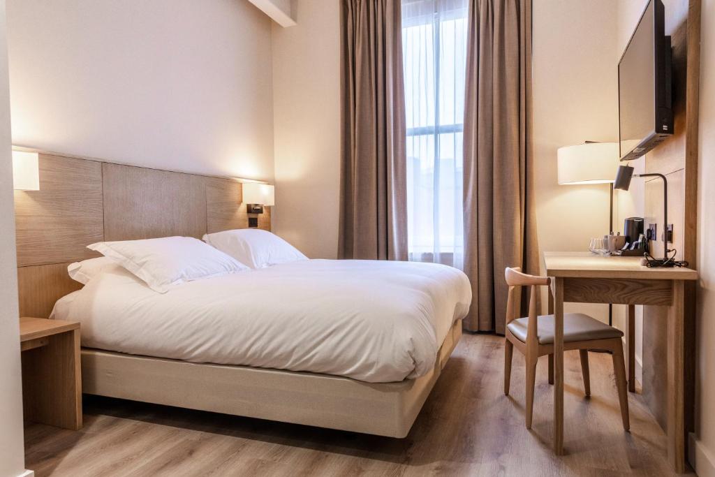 a hotel room with a bed and a desk and a television at School Lane Hotel in Liverpool ONE in Liverpool