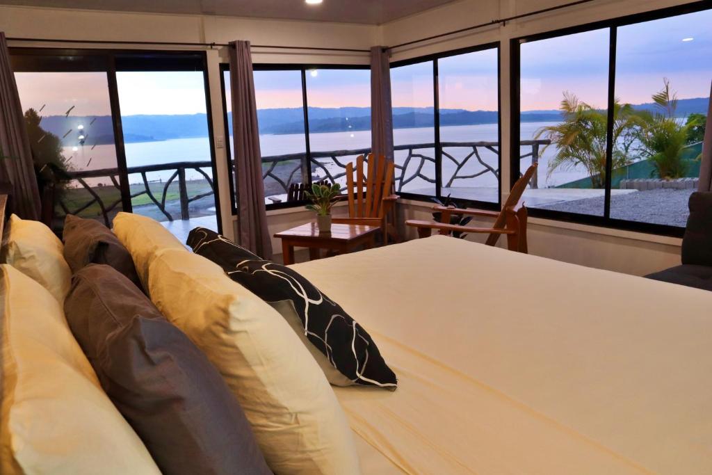 a living room with a couch and a view of the ocean at Love Cabin - Arenal Volcano & Lake views in El Fosforo