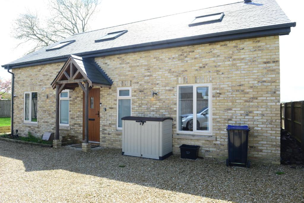 a brick house with a door and a window at Rollestone New Forest (HOT TUB) in Salisbury