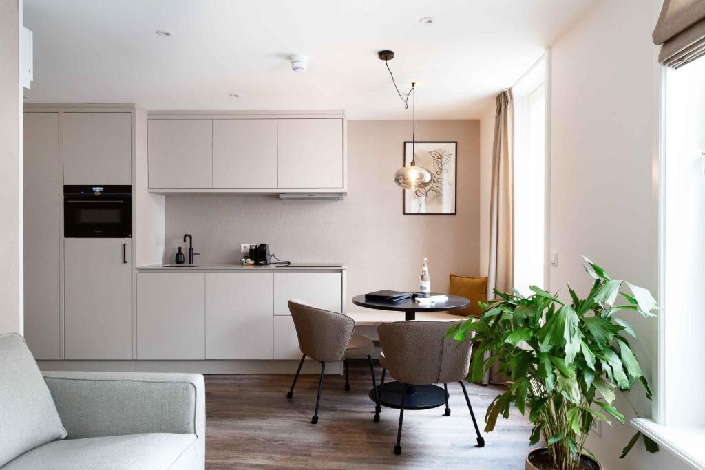 a kitchen and living room with a table and chairs at Finest Apartments in Haarlem
