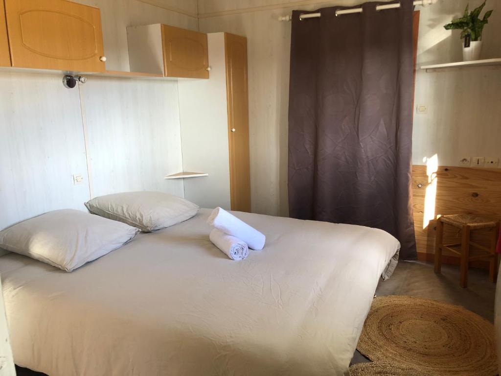 a bedroom with a bed with a towel on it at La foret des hérissons in Longessaigne