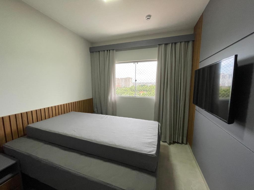 Giường trong phòng chung tại Caldas Novas Recanto do Bosque 6 Andar
