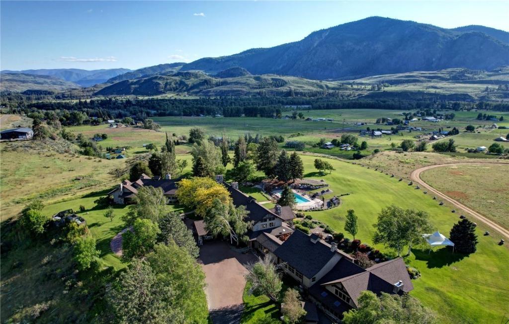 an aerial view of a farm with mountains in the background at Casia Lodge and Ranch in Twisp