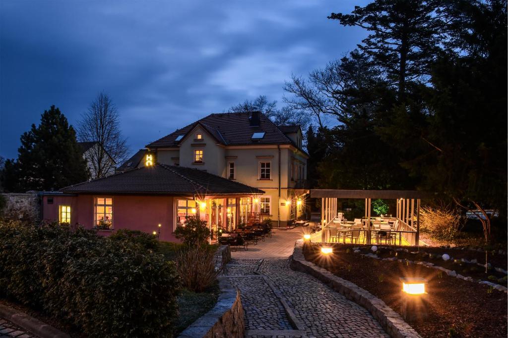 a house with lights in front of it at night at Hotel Villa Weiße in Kamenz