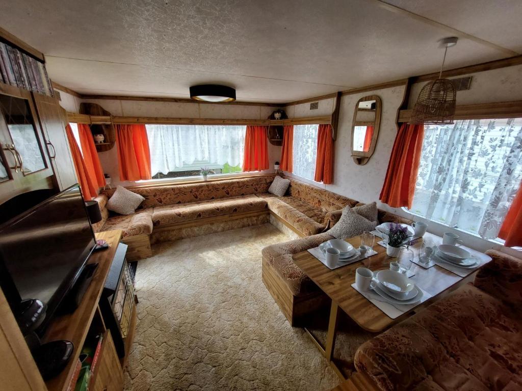 a living room with a couch and a table at Idyllic Family Holiday Caravan in Skegness