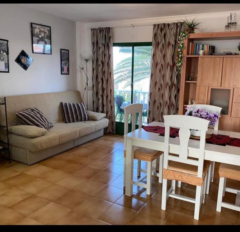 a living room with a couch and a table and chairs at Casa Daila in Costa de Antigua