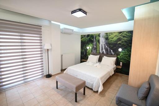 a large bedroom with a white bed and a chair at THE WHOLE PACKET Β3 center with parking in Larisa