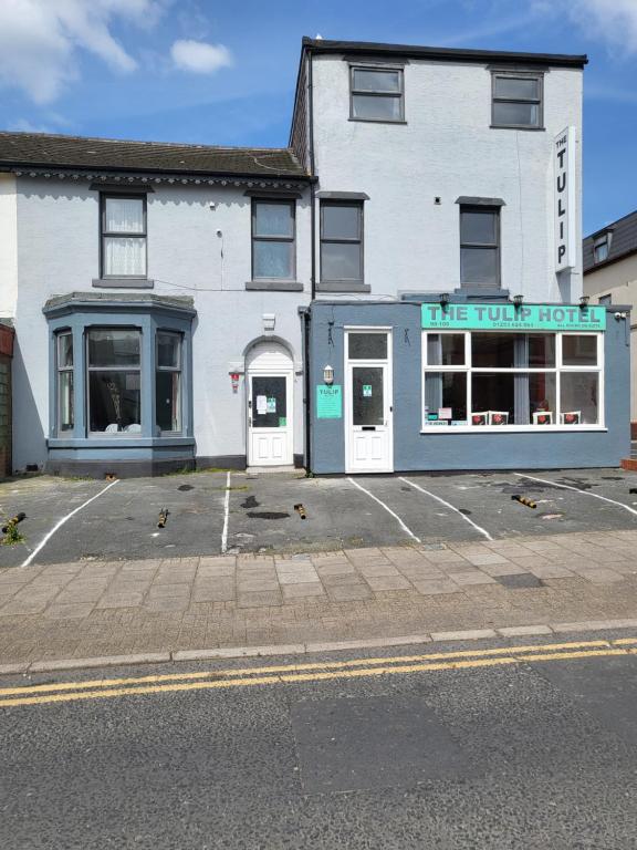 a large white building with a tire future hotel at Tulip Hotel Blackpool in Blackpool