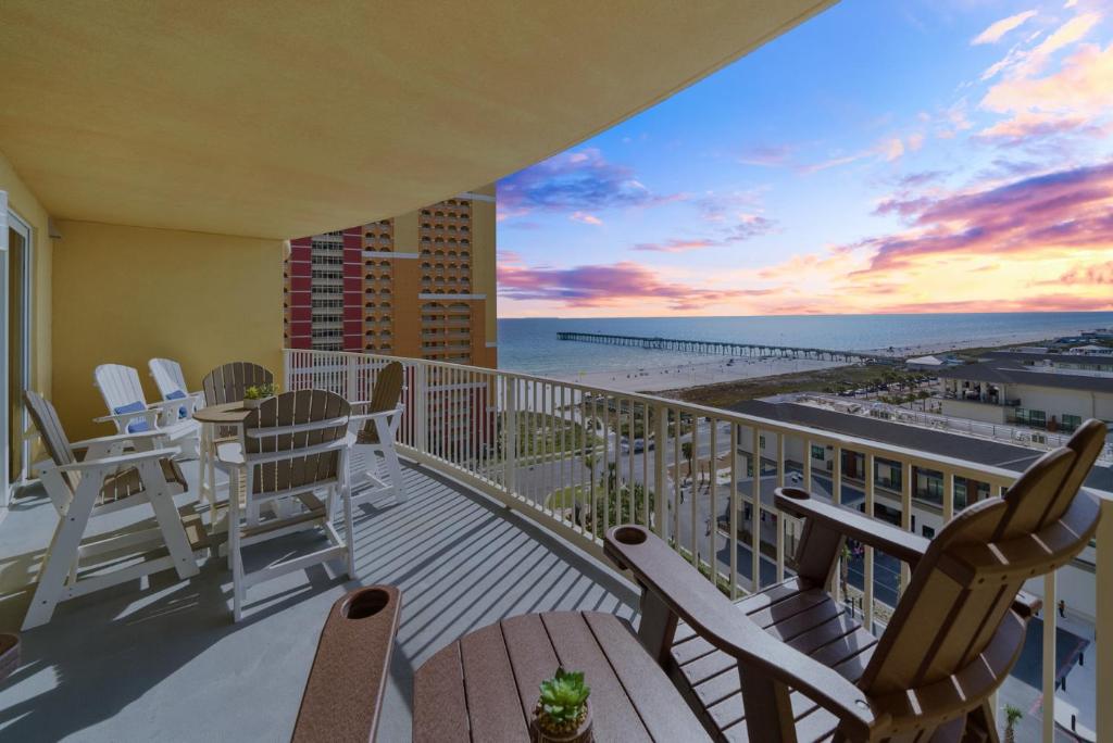 a balcony with chairs and a view of the beach at Calypso 3 Luxury Beach Vacation Sleeps 8 in Panama City Beach