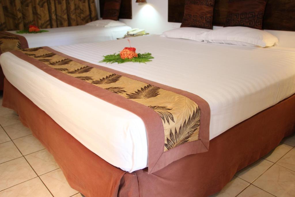 Postel nebo postele na pokoji v ubytování Capricorn International Hotel