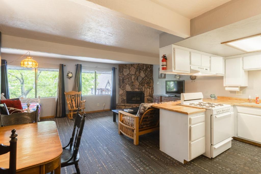 a kitchen and living room with a table and a stove at 01 - Brown Bear At Village Suites Inn Upstairs in Big Bear Lake