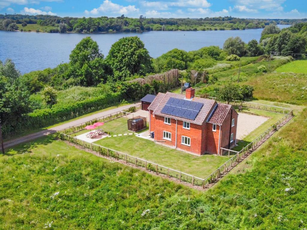 an aerial view of a house with solar panels on it at Old Alton Hall Farmhouse in Tattingstone