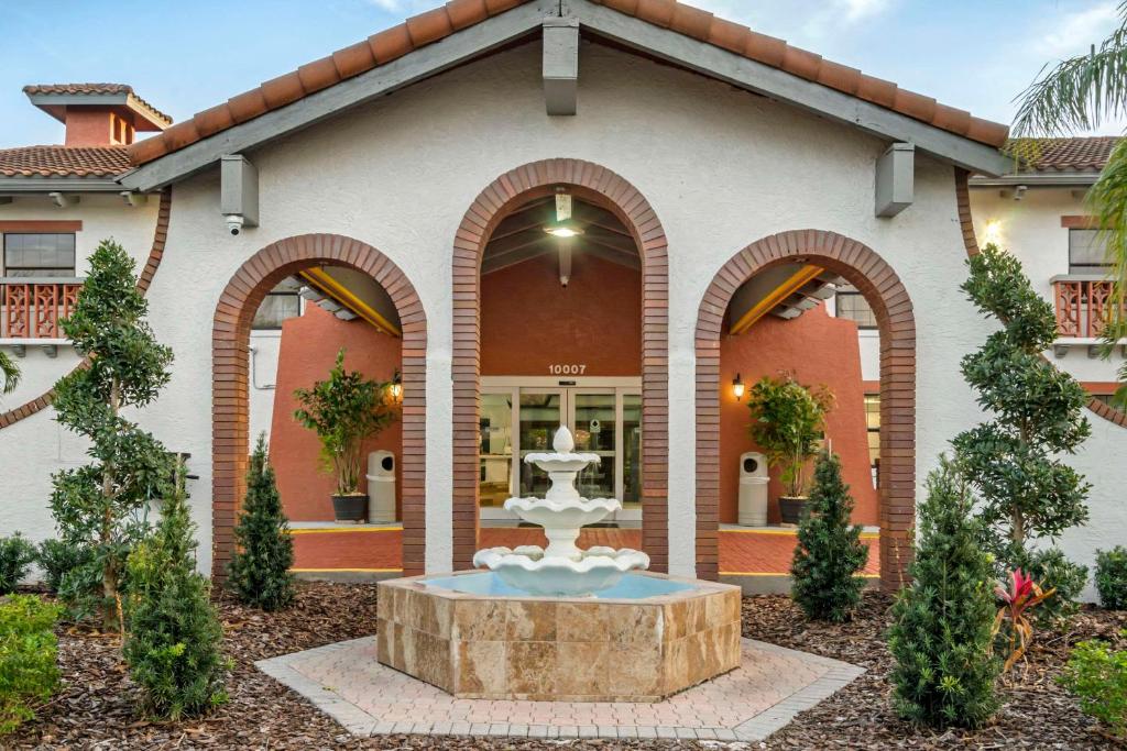 a building with a fountain in the front of it at Clarion Pointe Tampa-Brandon Near Fairgrounds and Casino in Tampa