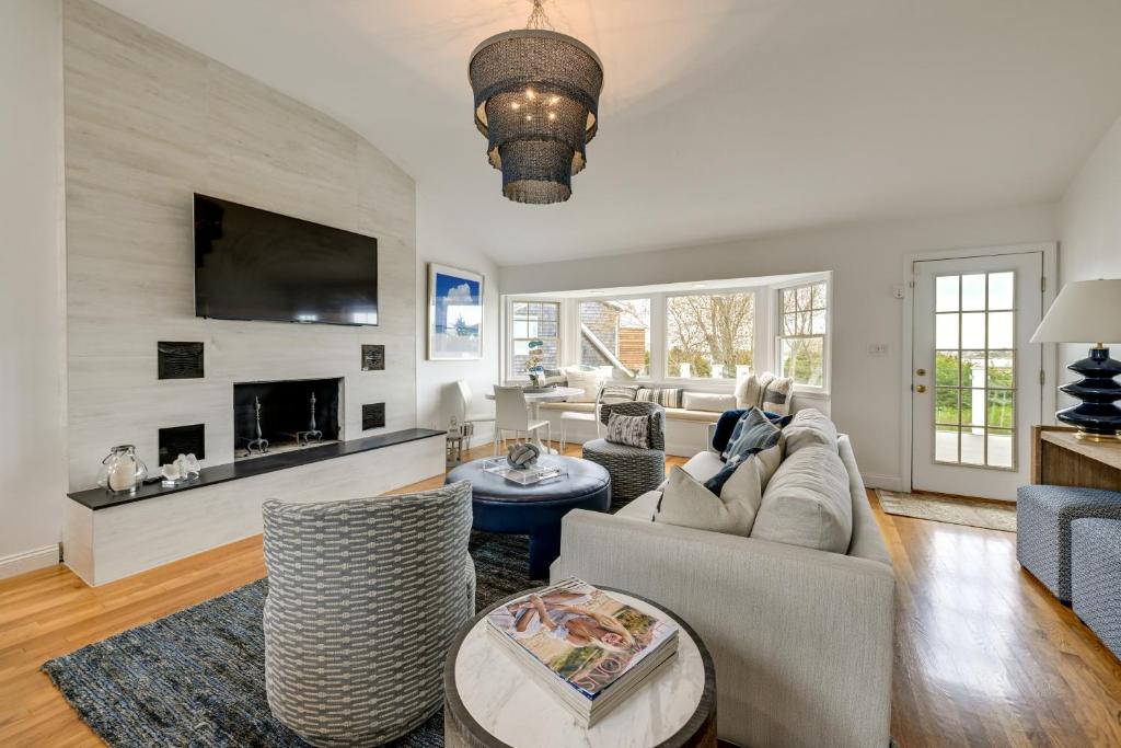 a living room with a couch and chairs and a tv at Stunning Westhampton Beach Home with Private Pool in Westhampton Beach