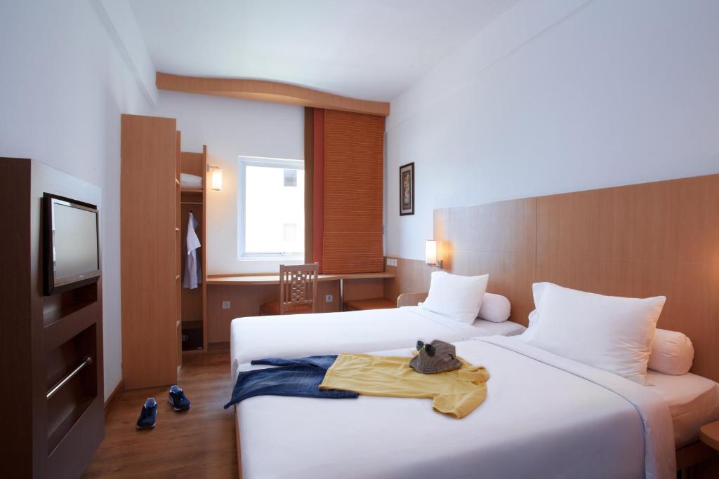 Postel nebo postele na pokoji v ubytování Ibis Bali Kuta