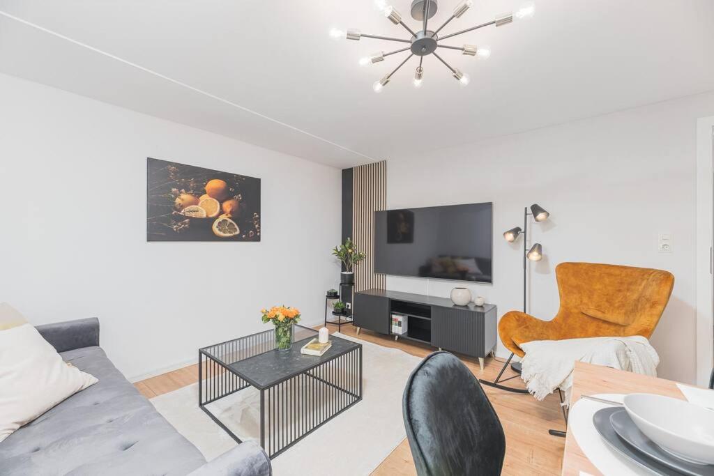 a living room with a couch and a table at Lemon Suites: Traumhaus in Filderstadt in Filderstadt