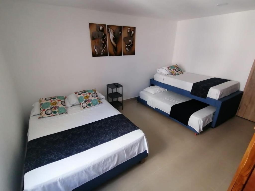 two beds in a small room with at Ocean blue Ed Conquistador in Cartagena de Indias