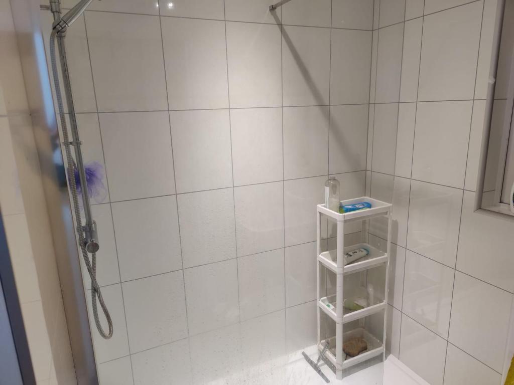 a bathroom with a shower with white tiled walls at Room for rent in Aberdeen